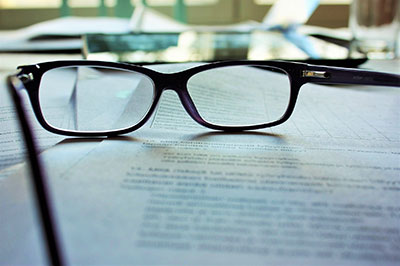 Glasses lying on papers